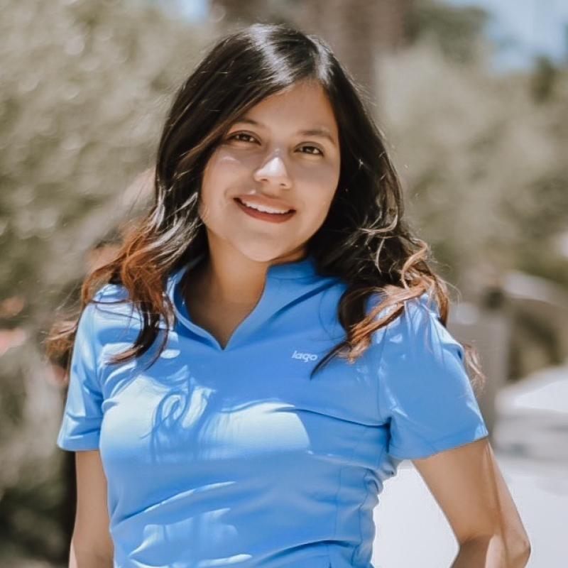 Image of a First-Gen Graduate student smiling and posing 